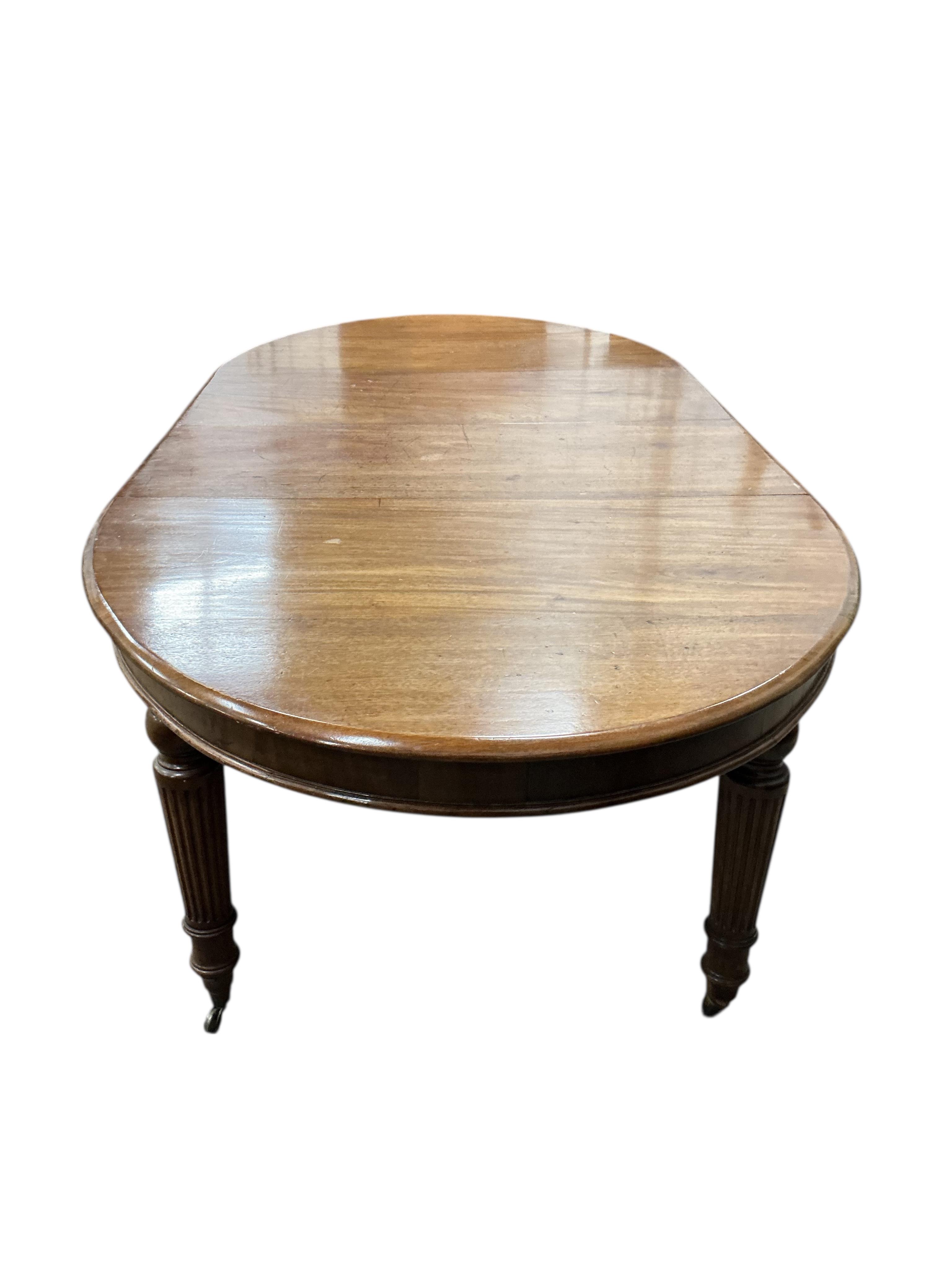A Victorian mahogany dining table, two spare leaves, 244cm extended, depth 115cm, height 71cm